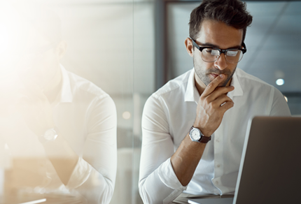 Pensive man at a computer.